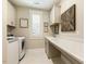 Well-equipped laundry room with modern appliances, custom cabinets, and a countertop folding area for convenience at 2716 Willow Rock Ln, Apex, NC 27523