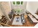 Open living room with tall ceilings, a fireplace, and large windows overlooking backyard at 2716 Willow Rock Ln, Apex, NC 27523