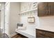 Functional mudroom with custom shelving, a comfortable bench, and stylish decor, enhancing home organization and comfort at 2716 Willow Rock Ln, Apex, NC 27523