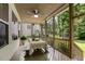 Charming screened-in porch with a ceiling fan, dining table, and views of the backyard at 2716 Willow Rock Ln, Apex, NC 27523