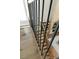 Hardwood staircase features twisted metal balusters and leads down to living area at 2716 Willow Rock Ln, Apex, NC 27523