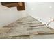 A view from below accenting a stone wall with wood beams and a modern chandelier at 2716 Willow Rock Ln, Apex, NC 27523