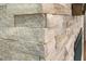 Close-up of the elegant stone wall surrounding the modern fireplace at 2716 Willow Rock Ln, Apex, NC 27523