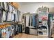 Spacious walk-in closet with shelving and hanging space for ample storage with organized clothing and luggage at 2716 Willow Rock Ln, Apex, NC 27523