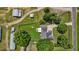 Aerial view of a home with lush green lawn, outbuildings, and mature trees surrounded by a black fence at 2856 Gwyn Rd, Elon, NC 27244
