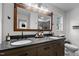 Bathroom featuring double vanity, large mirror, and modern fixtures at 2856 Gwyn Rd, Elon, NC 27244