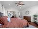 Relaxing bedroom with hardwood floors, ceiling fan, neutral tones, and plenty of natural light at 2856 Gwyn Rd, Elon, NC 27244