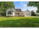 Charming white home with a welcoming front porch, attached garage, and a well-maintained lawn at 2856 Gwyn Rd, Elon, NC 27244