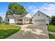 Attractive white home with an attached garage and manicured lawn, viewed from the driveway at 2856 Gwyn Rd, Elon, NC 27244