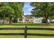 Well-maintained white home with front porch and attached garage, set back on a spacious green lawn at 2856 Gwyn Rd, Elon, NC 27244