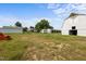 Expansive view of white farm buildings, set against a clear sky, showcasing the property's agricultural potential at 2856 Gwyn Rd, Elon, NC 27244