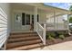 Charming front porch with rocking chairs and brick steps at 2856 Gwyn Rd, Elon, NC 27244