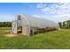 Features a partially open greenhouse with clear covering, allowing ample sunlight for plant growth at 2856 Gwyn Rd, Elon, NC 27244