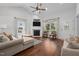 Bright living room featuring hardwood floors, a fireplace, a ceiling fan, and natural light at 2856 Gwyn Rd, Elon, NC 27244