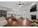 Cozy living room with hardwood floors, fireplace, vaulted ceiling, and open to dining area at 2856 Gwyn Rd, Elon, NC 27244