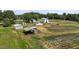 Aerial view of multiple outbuildings including barns, sheds, and farm land at 2856 Gwyn Rd, Elon, NC 27244
