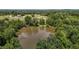High aerial view of the pond, and the surrounding forest at 2856 Gwyn Rd, Elon, NC 27244
