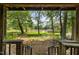 Picturesque view from a covered porch, overlooking a tranquil lake surrounded by lush trees at 2856 Gwyn Rd, Elon, NC 27244