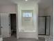 Bright bathroom featuring a soaking tub, glass-enclosed shower, and neutral color palette at 290 Busterfield Ct, Benson, NC 27504