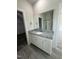 Bathroom vanity with granite countertops, white cabinets, and tile flooring at 290 Busterfield Ct, Benson, NC 27504
