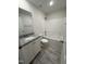 Bright bathroom featuring a granite vanity, white cabinets, and a shower-tub combo with tile floors at 290 Busterfield Ct, Benson, NC 27504