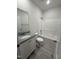 Full bathroom with granite counters, shower and tub, and white cabinets at 290 Busterfield Ct, Benson, NC 27504