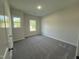 Bright bedroom with carpet, two windows, base molding, and neutral walls at 290 Busterfield Ct, Benson, NC 27504