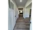 Inviting entryway with wood-look floors and white trim, leading into the home's interior at 290 Busterfield Ct, Benson, NC 27504
