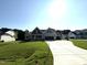 Beautiful gray home with a three-car garage and a long driveway on a verdant lot at 290 Busterfield Ct, Benson, NC 27504