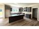 Modern gray kitchen featuring an island, granite countertops, and stainless steel appliances at 290 Busterfield Ct, Benson, NC 27504