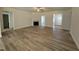 Spacious living room with wood-look floors, a fireplace, and an open floor plan at 290 Busterfield Ct, Benson, NC 27504