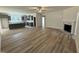 Open-concept living area features wood-look floors, a fireplace, and a glimpse of the gray kitchen at 290 Busterfield Ct, Benson, NC 27504