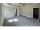 Large main bedroom featuring a tray ceiling, neutral carpet, and an ensuite bathroom at 290 Busterfield Ct, Benson, NC 27504