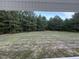 Backyard featuring trees and grassy area at 295 Eason Creek Way, Clayton, NC 27527