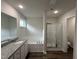 Bright bathroom featuring double vanity and glass-enclosed shower at 295 Eason Creek Way, Clayton, NC 27527