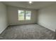 Bedroom with plush carpeting and plenty of natural light at 295 Eason Creek Way, Clayton, NC 27527