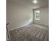 Bedroom features neutral walls, plush carpets, and bright window at 295 Eason Creek Way, Clayton, NC 27527
