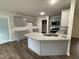 Modern kitchen featuring gray cabinets, granite countertops, and stainless steel appliances at 295 Eason Creek Way, Clayton, NC 27527
