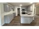 Modern kitchen featuring gray cabinets, granite countertops, and stainless steel appliances at 295 Eason Creek Way, Clayton, NC 27527