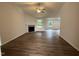 Inviting living room featuring a modern fireplace, large windows, and hardwood-style flooring at 295 Eason Creek Way, Clayton, NC 27527
