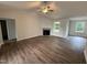 Open-concept living room featuring a fireplace, large windows, and wood-look flooring at 295 Eason Creek Way, Clayton, NC 27527