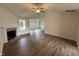 Spacious open-concept living room with luxury vinyl floors and a cozy fireplace at 295 Eason Creek Way, Clayton, NC 27527