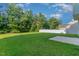 A wide, well-kept backyard with a partial concrete patio and a tall privacy fence at 3036 Landing Falls Ln, Raleigh, NC 27616