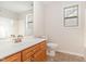 Well-lit bathroom features a single sink vanity, mirror, and toilet, with neutral tile flooring at 3036 Landing Falls Ln, Raleigh, NC 27616