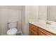 Cozy bathroom with oak vanity, sink, white toilet and neutral paint at 3036 Landing Falls Ln, Raleigh, NC 27616