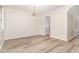 Bright dining room with new hard surface floors, modern chandelier, view into hall at 3036 Landing Falls Ln, Raleigh, NC 27616