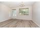 Bright dining room with new hard surface floors, modern chandelier and new paint at 3036 Landing Falls Ln, Raleigh, NC 27616