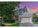 Charming two-story home with a well-manicured lawn, two car garage, and craftsman style details at 3036 Landing Falls Ln, Raleigh, NC 27616