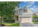 Charming two-story home with a well-manicured lawn, two car garage, and craftsman style details at 3036 Landing Falls Ln, Raleigh, NC 27616
