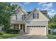 Charming two-story home with a well-manicured lawn, two car garage, and craftsman style details at 3036 Landing Falls Ln, Raleigh, NC 27616
